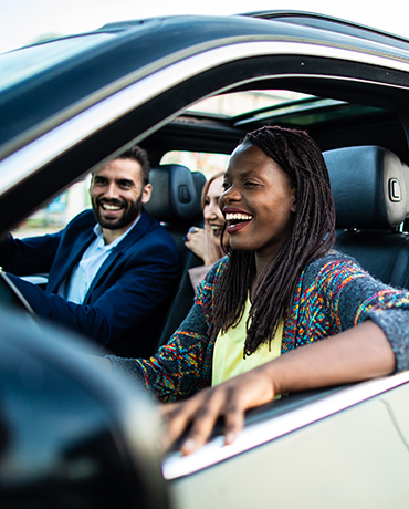 An African American woman driving a car with a man in the passenger seat