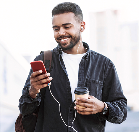 man on phone with coffee in hand