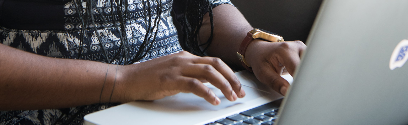 Skinny version of woman on computer wearing watch