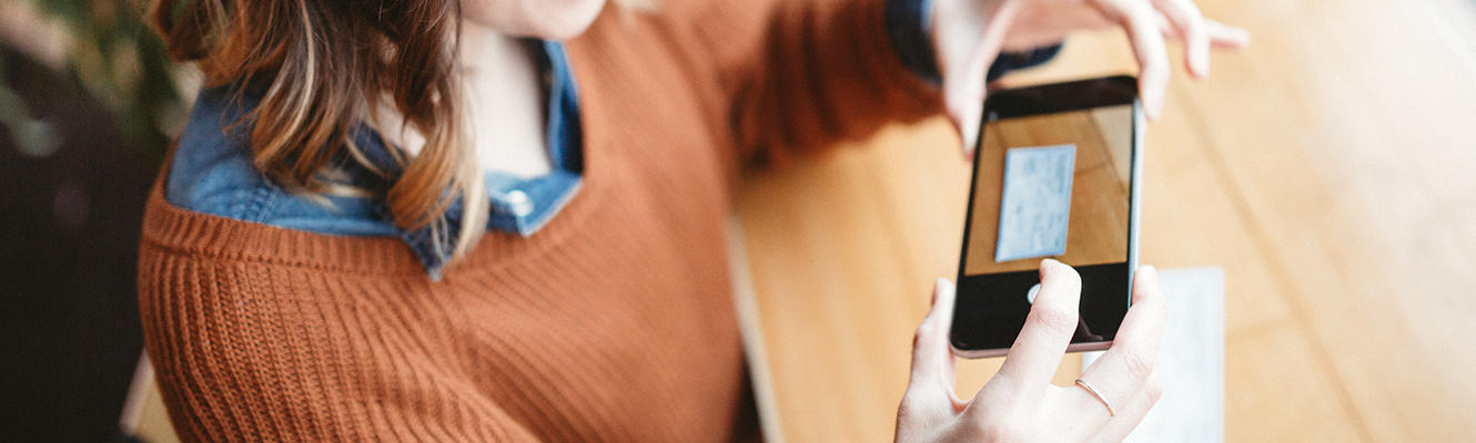 woman depositing a check via her mobile phone