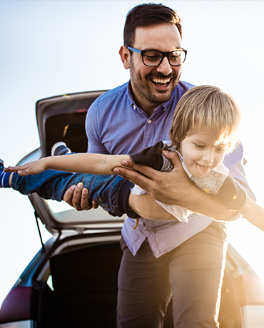 man playing airplane with child