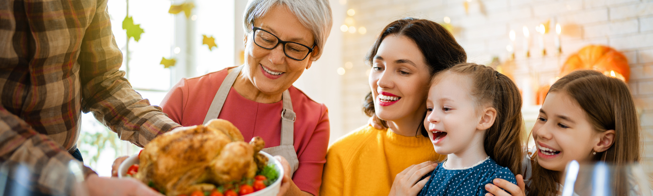 A family sitting together and being served Thanksgiving turkey.