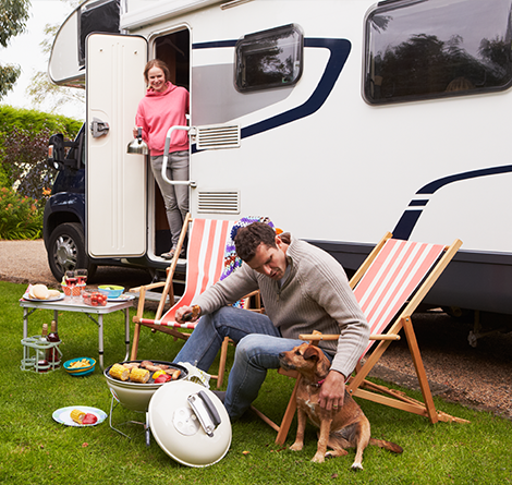 Family sitting outside of RV