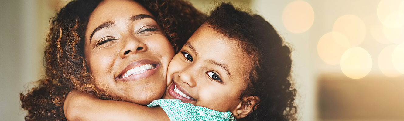 Mom and daughter hugging and smiling