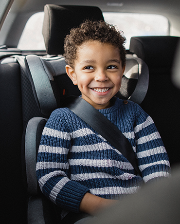 kid buckled in backseat of car