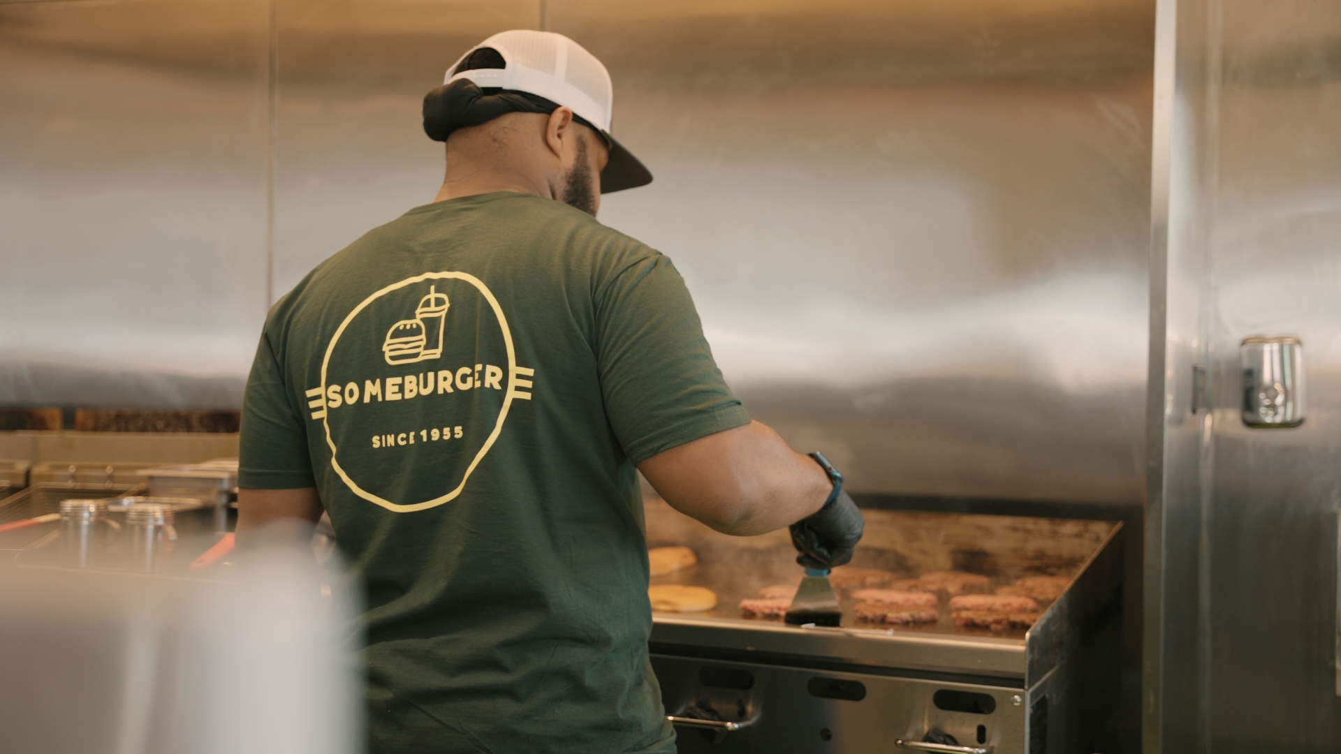 Someburger employee working in a kitchen.
