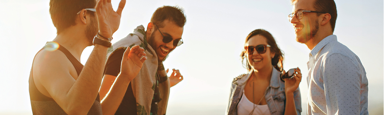 11:27 AMClaude responded: A group of four young adults laughing and socializing outdoors in warm golden sunlight, with some wearing sunglasses, enjoying a carefree moment together.A group of four young adults laughing and socializing outdoors in warm golden sunlight, with some wearing sunglasses, enjoying a carefree moment together