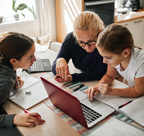 Teacher helping students with online learning