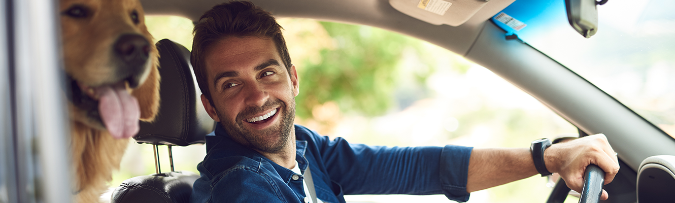 Man in car with dog