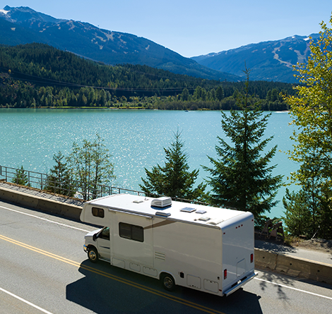 RV driving by lake