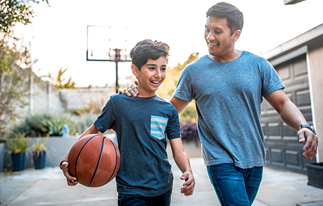 father and son playing basketball