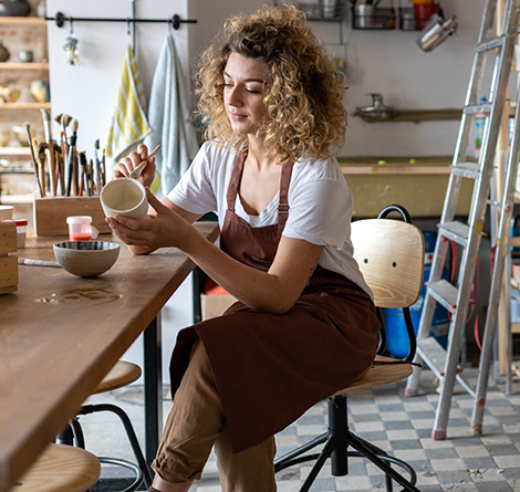 woman painting pottery