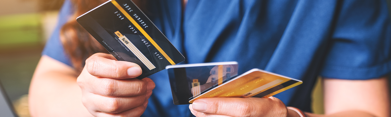 guy holding three credit cards