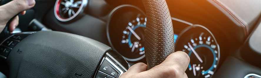 A close of shot of a car steering wheel.