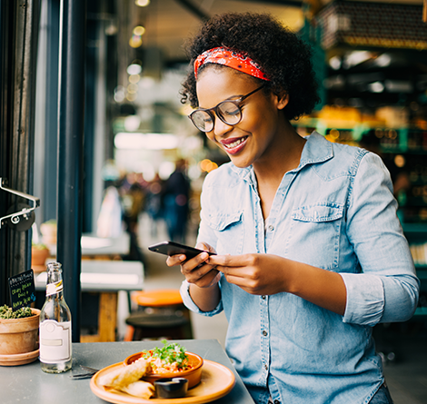 Woman smiling and looking at phone