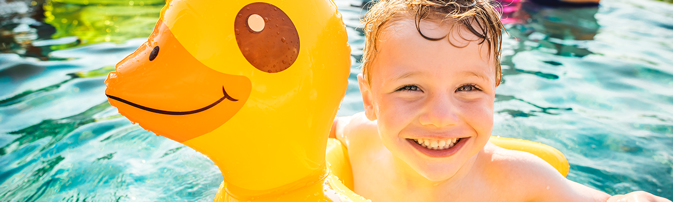 Boy in pool on yellow ducky float