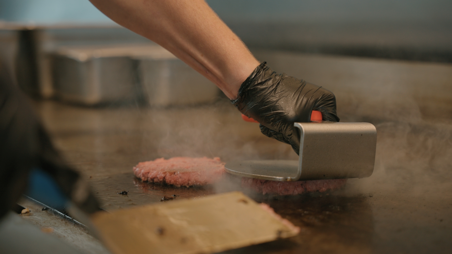 A burger cooking on a stove.
