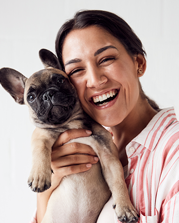 woman hugging frenchie bulldog