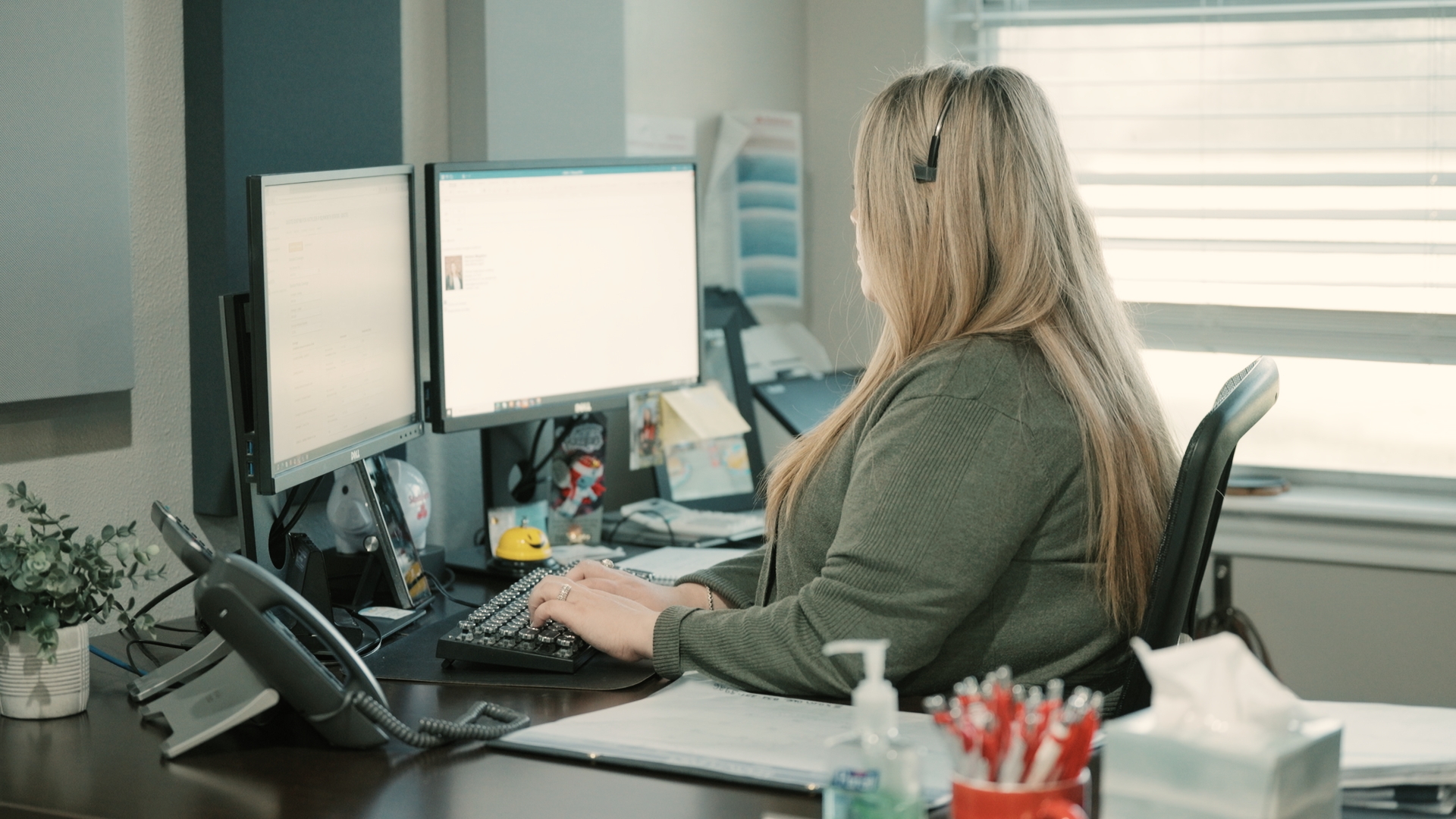 A woman sitting and working at her desk.

