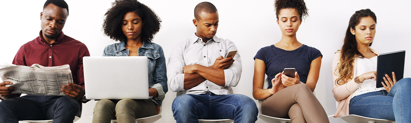 People sitting in line on different devices