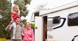 family standing beside RV