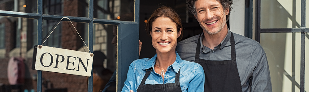 business owners in front of store