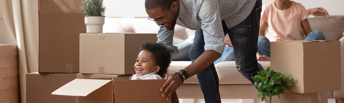 family playing in moving boxes