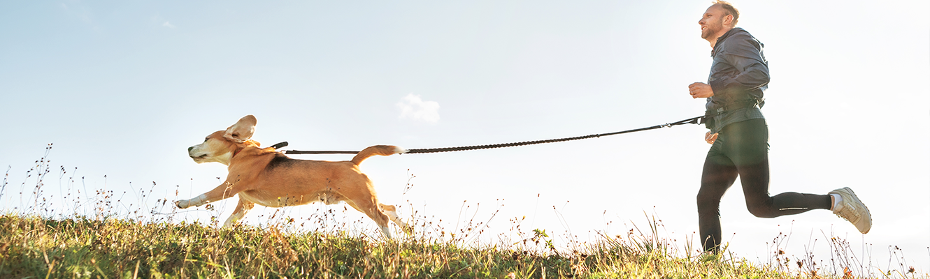 man running with dog