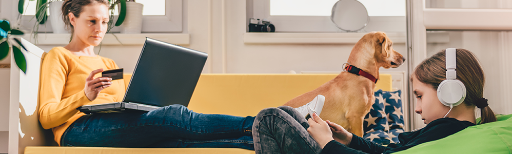 woman sitting on computer with young girl