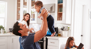 Dad holding baby up above head