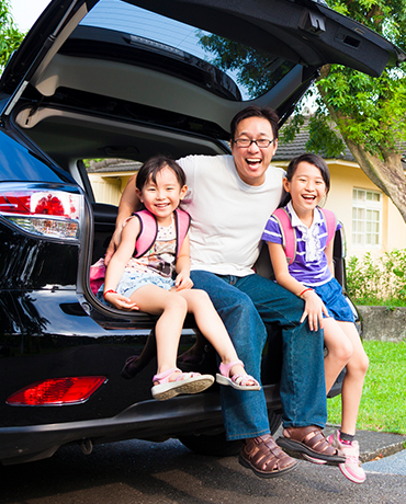 Dad and kids in back of SUV