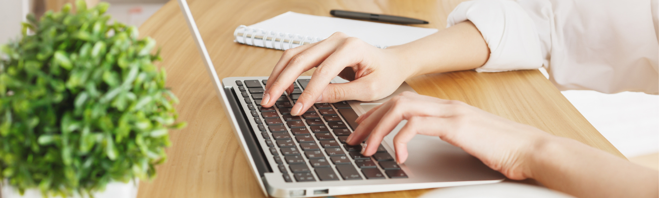 Person typing on computer at their desk