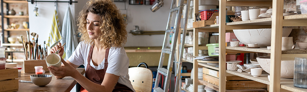 A woman working on her pottery business