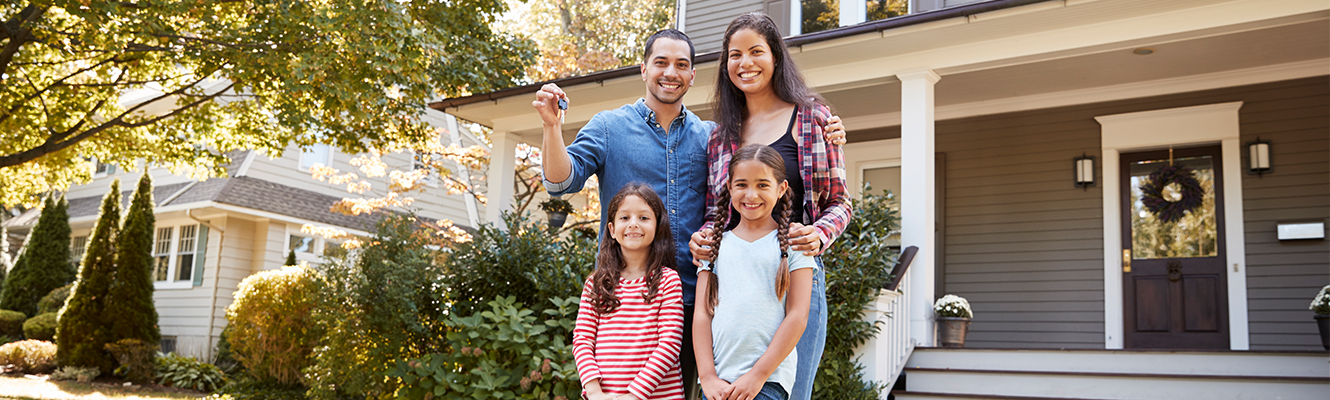 Family in front of new home