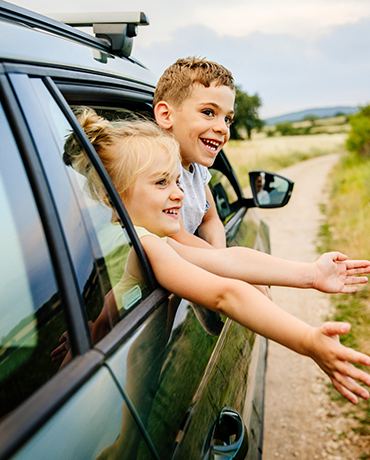 kids hanging out of car