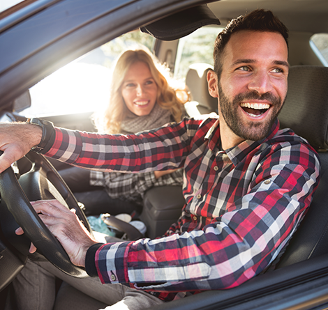 couple in car smiling