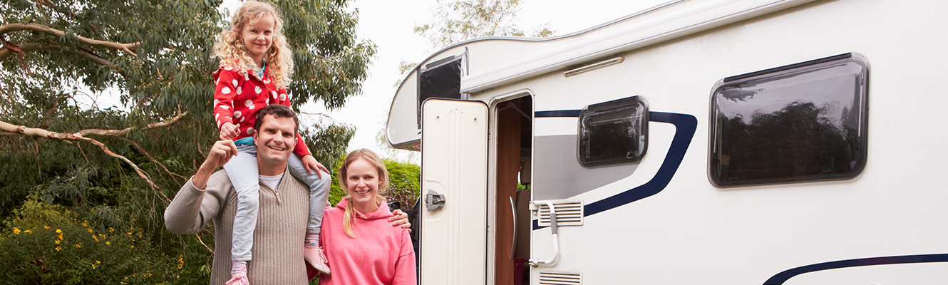 Family standing outside of RV