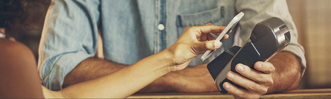 A merchant taking a credit card payment.