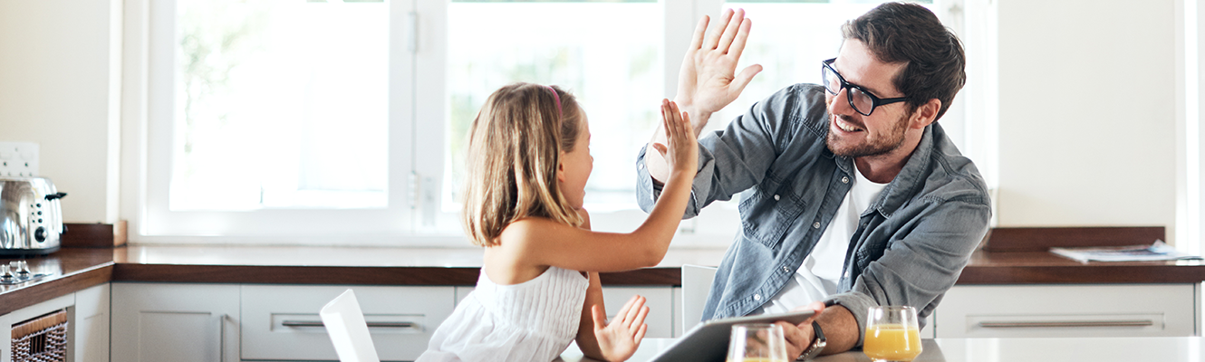 Dad and daughter giving each other a high five