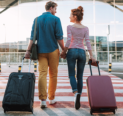 couple walking with suitcases
