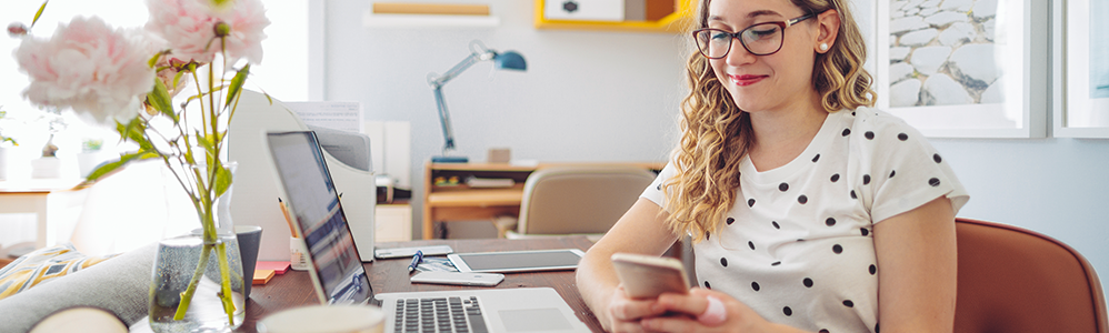 girl sitting on phone and computer