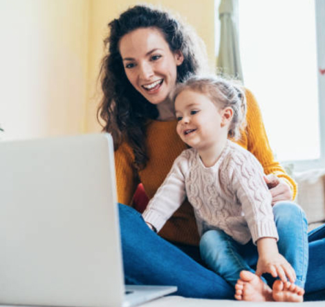 mom and kid on computer watching peppa pig