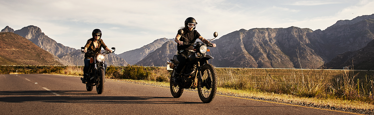 motorcycles on highway with mountains